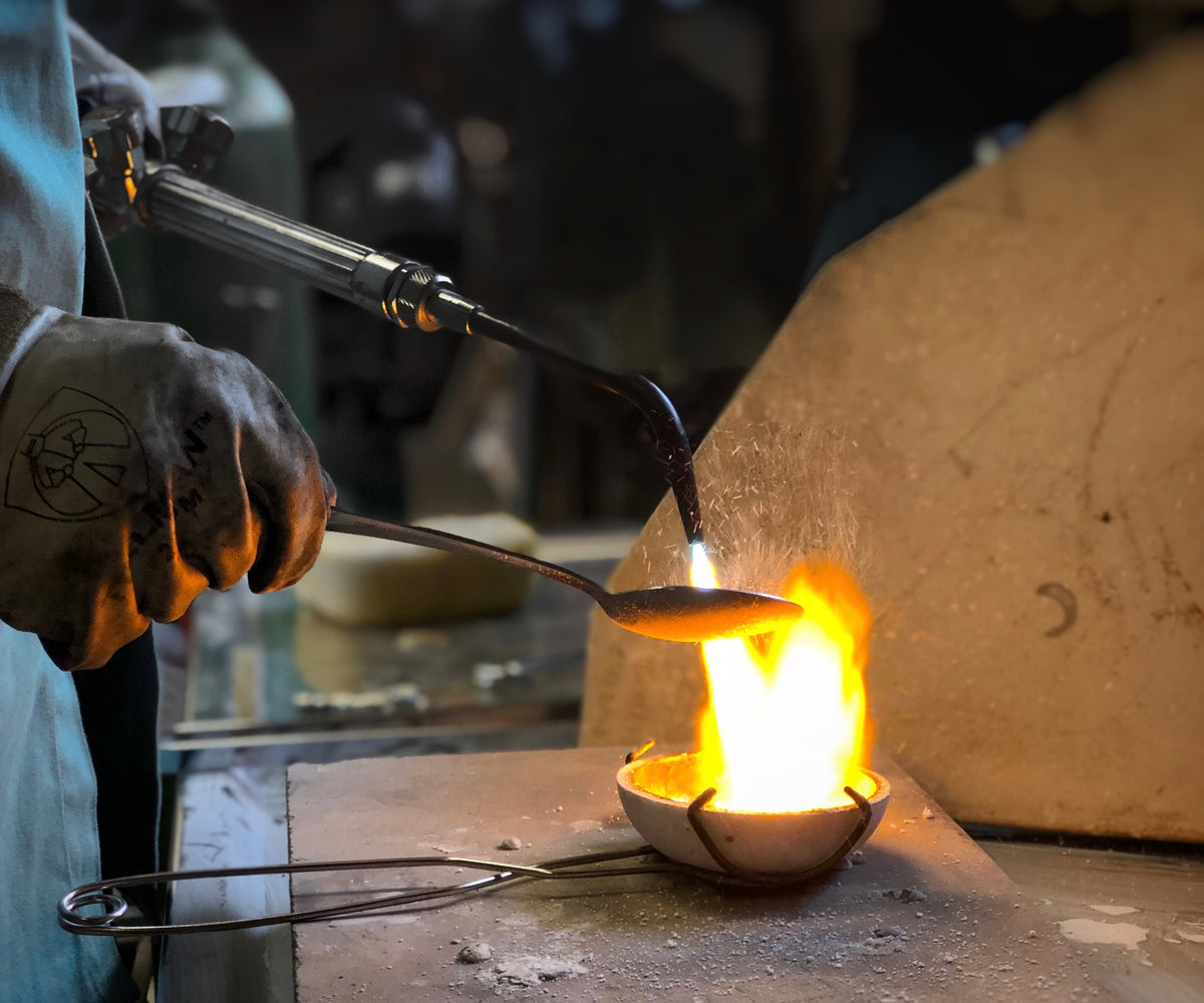 Johnny Ninos casting silver spoons for Ninos Studio's home collection.